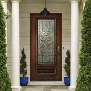 Decorative glass front door featuring an elegant glass design and wood framing at a residential entrance.