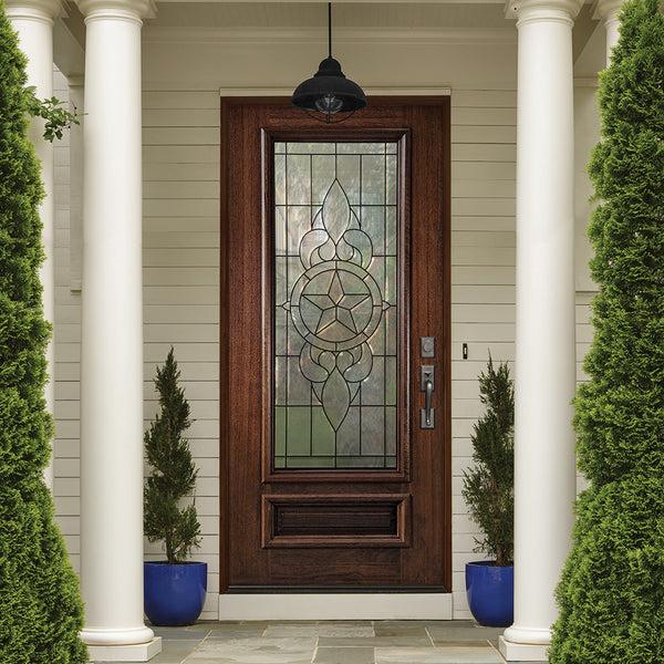 Decorative glass front door featuring an elegant glass design and wood framing at a residential entrance.