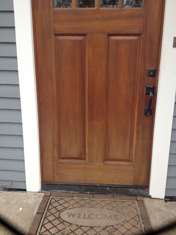Wood front door care Sarasota example showing subtle fading and finish wear on a residential entry door